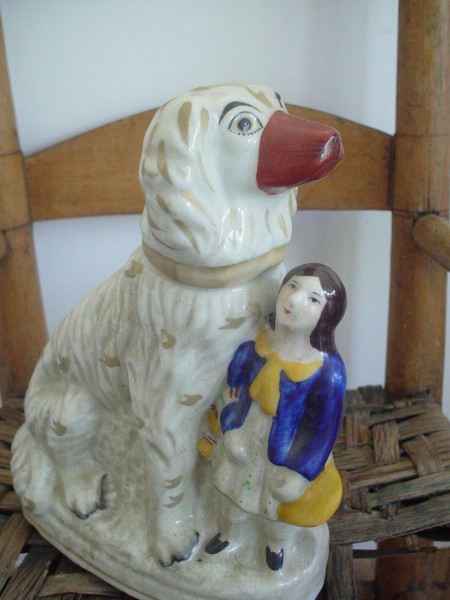 Staffordshire figurine of a spaniel dog and a young boy